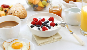 Abbildung eines Frühstücks, mit Kaffee, Müsli, Spiegelei, Marmelade