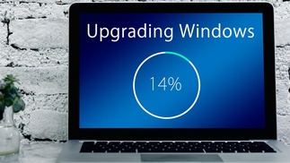 Laptop mit Schriftzug Upgrading Windows 14 %