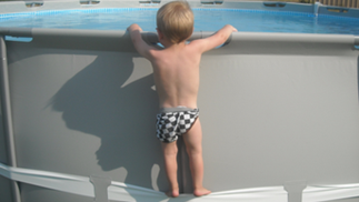 Kind steht auf Poolbeine