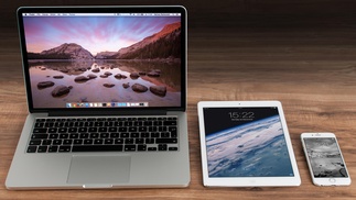 Laptop, Tablett und Smartphone auf Holztisch